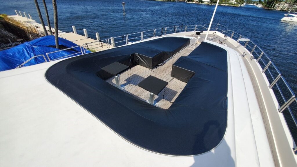 White yacht deck with black water proof weather protection cover
