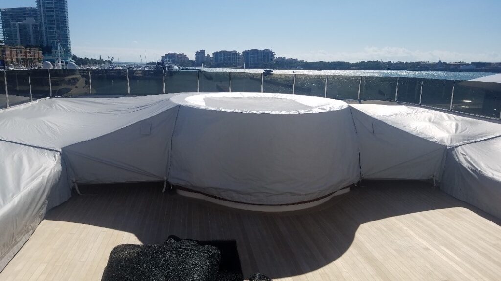 Yacht deck with hot tub in the center, covered with a waterproof protective cover