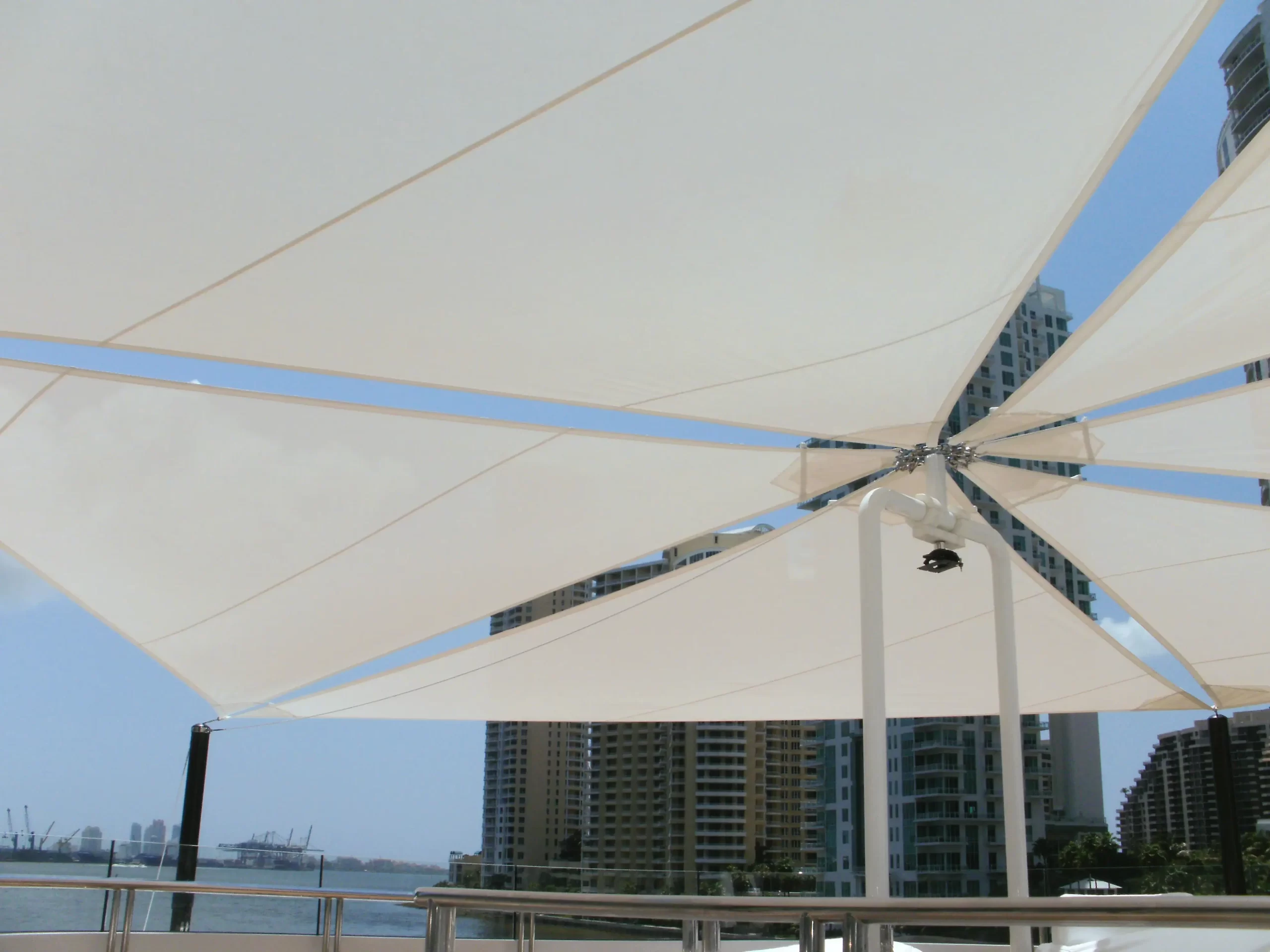 A sail awning in crisp white, complementing the clean lines and modern aesthetic of the yacht's exterior while providing relief from the sun's rays.