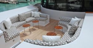 Stylish outdoor cushions arranged on a teakwood deck, complementing the yacht's luxurious aesthetic while providing comfort for leisurely moments at sea.