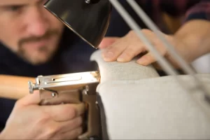 Person fixing yacht upholstery