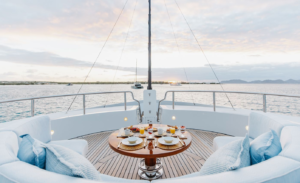 Breakfast set up on yacht deck by cushions and furnishings