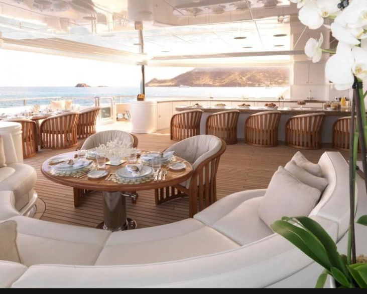 Yacht furnishings, cushions and a set table ready for charter guests