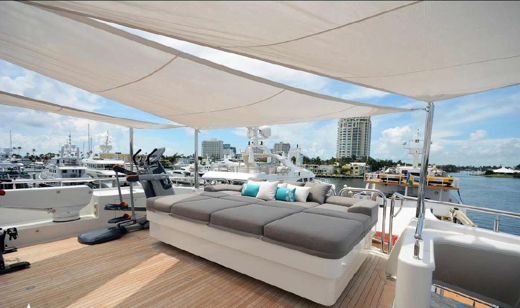 Yacht sail awning with slit in the middle of grey yacht furnishings with blue cushions.