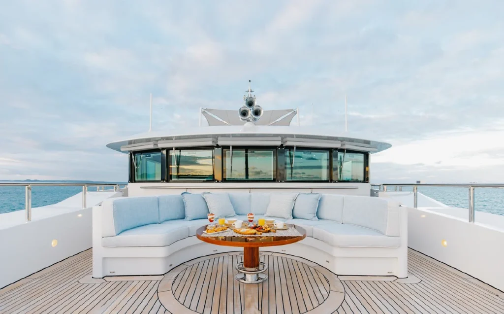 Yacht semi circle furnishings with yacht cushions and table.