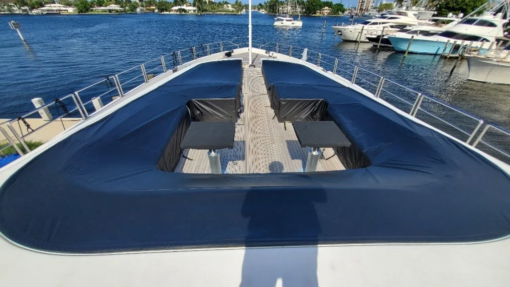 Exterior upholstery of superyacht with black weatherproof covers.