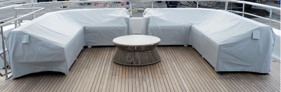 Final yacht sofa with covers fitted on a yacht deck.